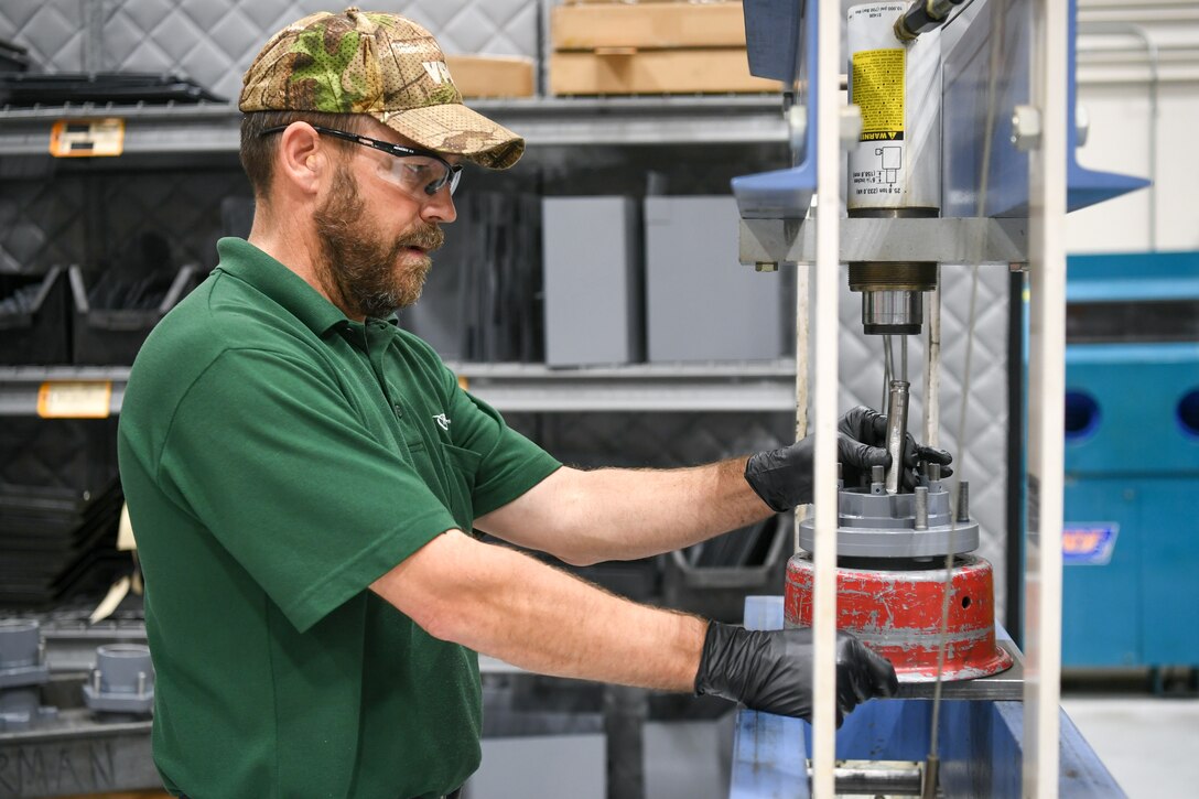 Tommy Cook, 309th Electronics Maintenance Group, presses out races on a rear hub of a MH-2 bomb lift April 29, 2020, at Hill Air Force Base, Utah. The 309th EMXG in the Ogden Air Logistics Complex provides repair and overhaul for exchangeable assets for a multitude of systems on a wide assortment of Air Force weapons systems including fighter aircraft, intercontinental ballistic missiles, powered aerospace ground equipment, tactical shelters, as well as refurbishment of radomes worldwide. (U.S. Air Force photo by Cynthia Griggs)