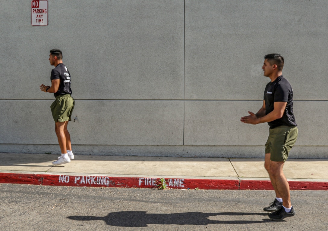 U.S Marines Staff Sgt. Jean Orozco (left), Staff Sgt. Eduardo Santillan (right), recruiters with Recruiting Station Orange County,  lead their enlistees and guests during a virtual circuit workout at Recruiting Sub-Station Westminster, May 8 2020. Recruiting Sub-Station Westminster continues to stay dedicated to their enlistees in preparing them for bootcamp by telecommuting physical training. (U.S. Marine Corps photo by Sgt. Sarah Ralph)