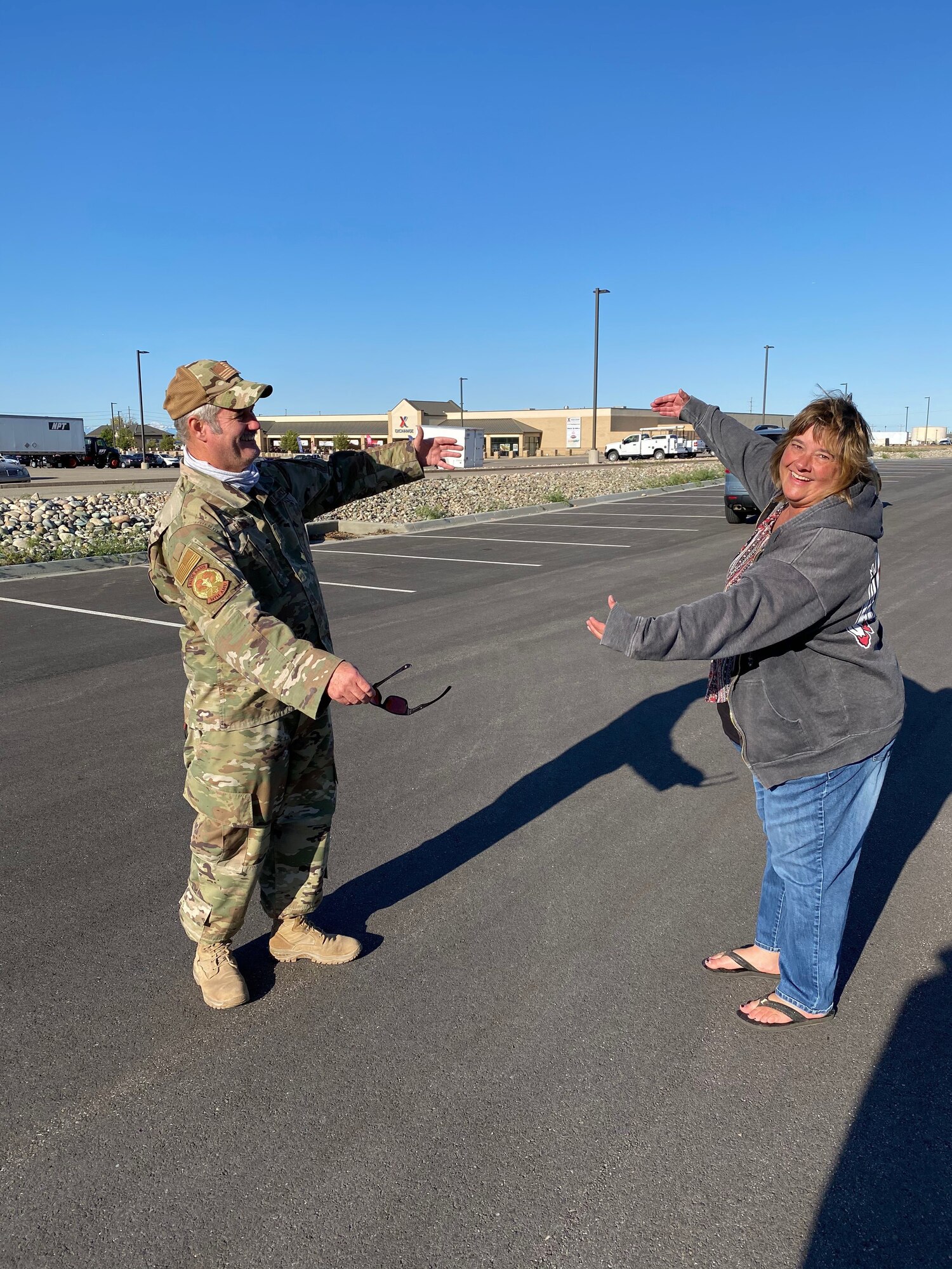 Chief Master Sgt. Craig Fowler, superintendent for the 419th Aircraft Maintenance Squadron, gives his wife, Tammy, a long-distance air hug after arriving home from a six-month deployment to the Middle East.