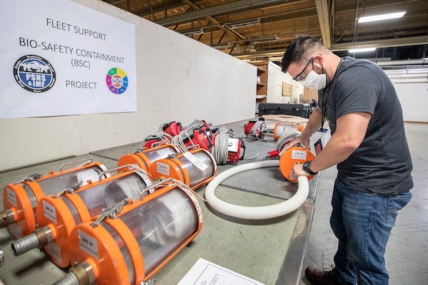 Kaimana Lutey, a fabric worker with Shop 64, Sail Loft prepares to test the negative pressure air handling system for a biocontainment system May 11, 2020 in the Building 460, at Puget Sound Naval Shipyard & Intermediate Maintenance Facility in Bremerton, Washington.