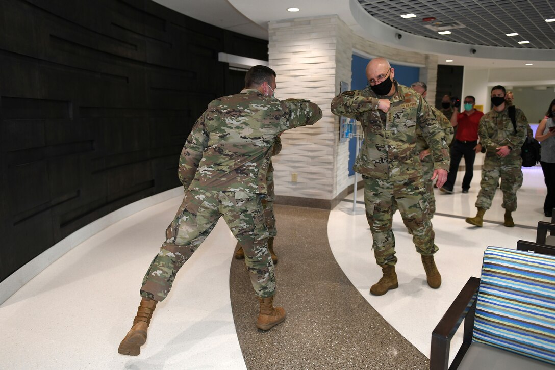 Photo shows Baker and Bunch bumping elbows like a "high five."