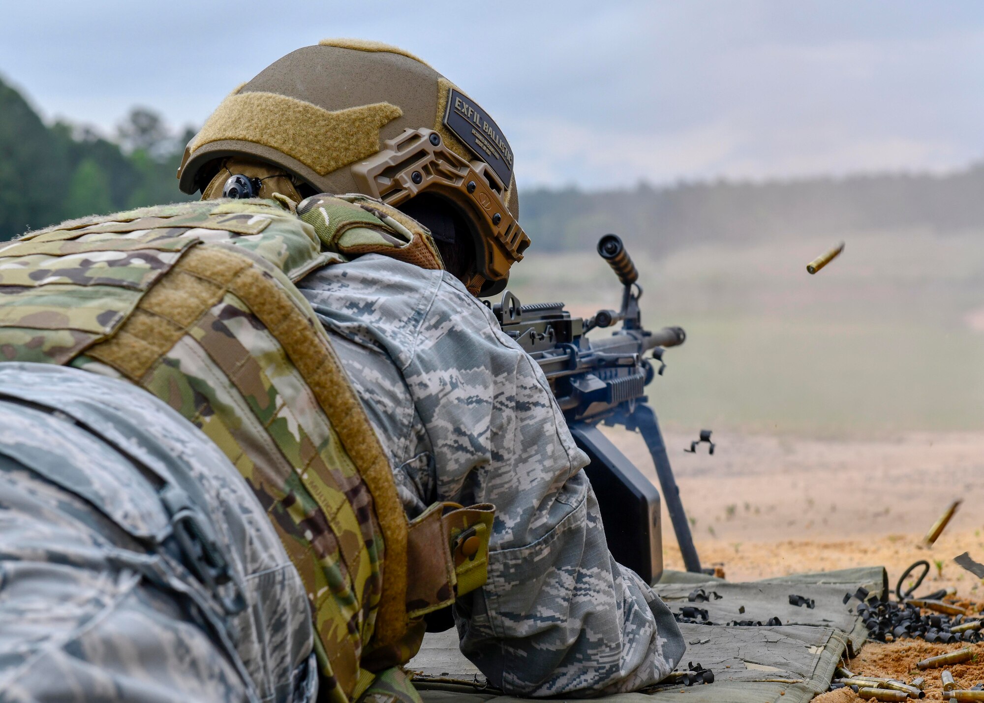 Airman First Class Christopher Eastes, 4th Security Forces Squadron patrolman, fires an M249 light machine gun at Fort Bragg, North Carolina, May 6, 2020. The M249 bolt assembly provides stripping, cambering, firing, and extraction, using the propellant gases and recoil spring for power. (U.S. Air Force photo by Airman First Class Kimberly Barrera)