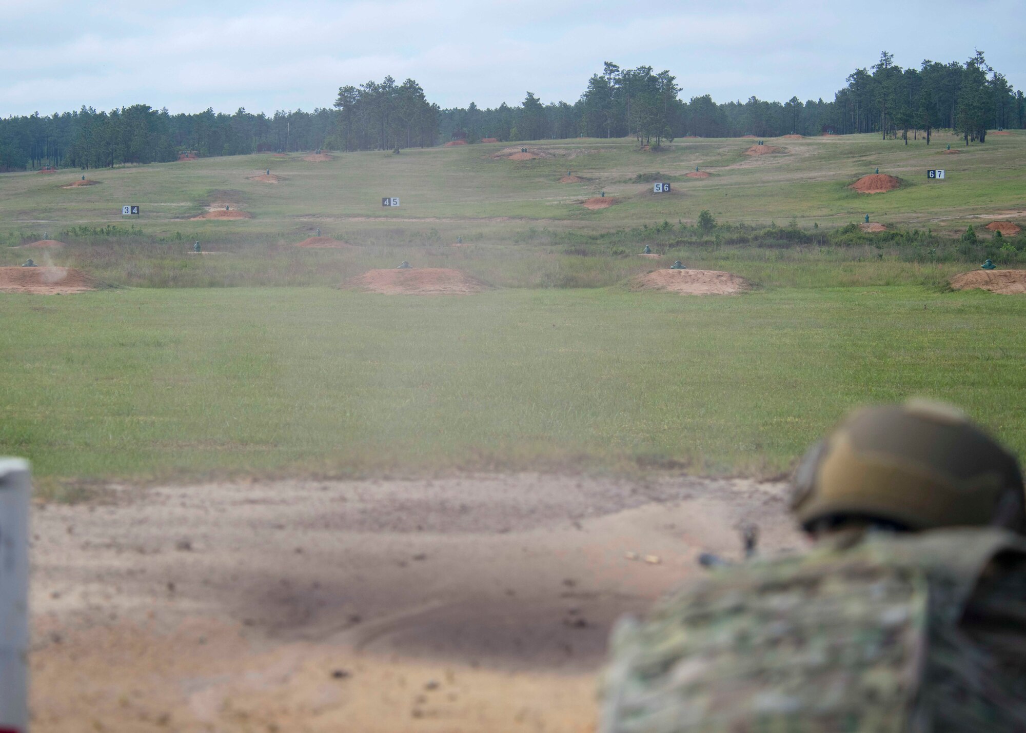 Senior Airman Kyle Runk, 4th Security Forces Squadron patrolman, fires an M249 light machine gun at a range on Fort Bragg, North Carolina, May 6, 2020. The machine gun full distance range had pop-up targets arranged at different distance and heights. (U.S. Air Force photo by Airman First Class Kimberly Barrera)