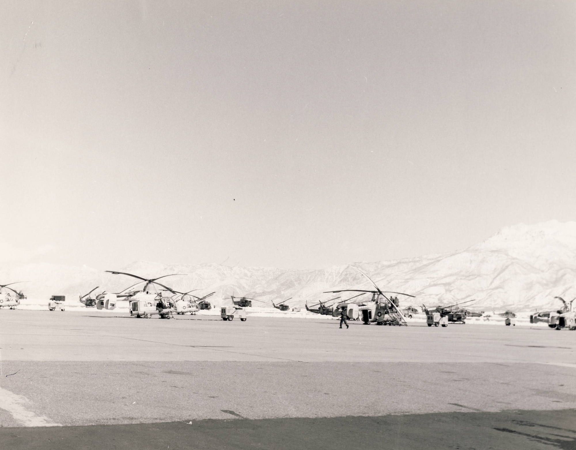 The 1550th Aircrew Training and Test Wing's assigned aircraft consisted of 68 helicopters and six fixed-wing HC-130s. This photograph shows the wing’s Kaman HH-43 Huskie helicopters on the ramp at Hill AFB (foreground) and some of the unit’s Bell UH-1 Iroquois and Sikorsky HH-3 Jolly Green Giant helicopters in the background.