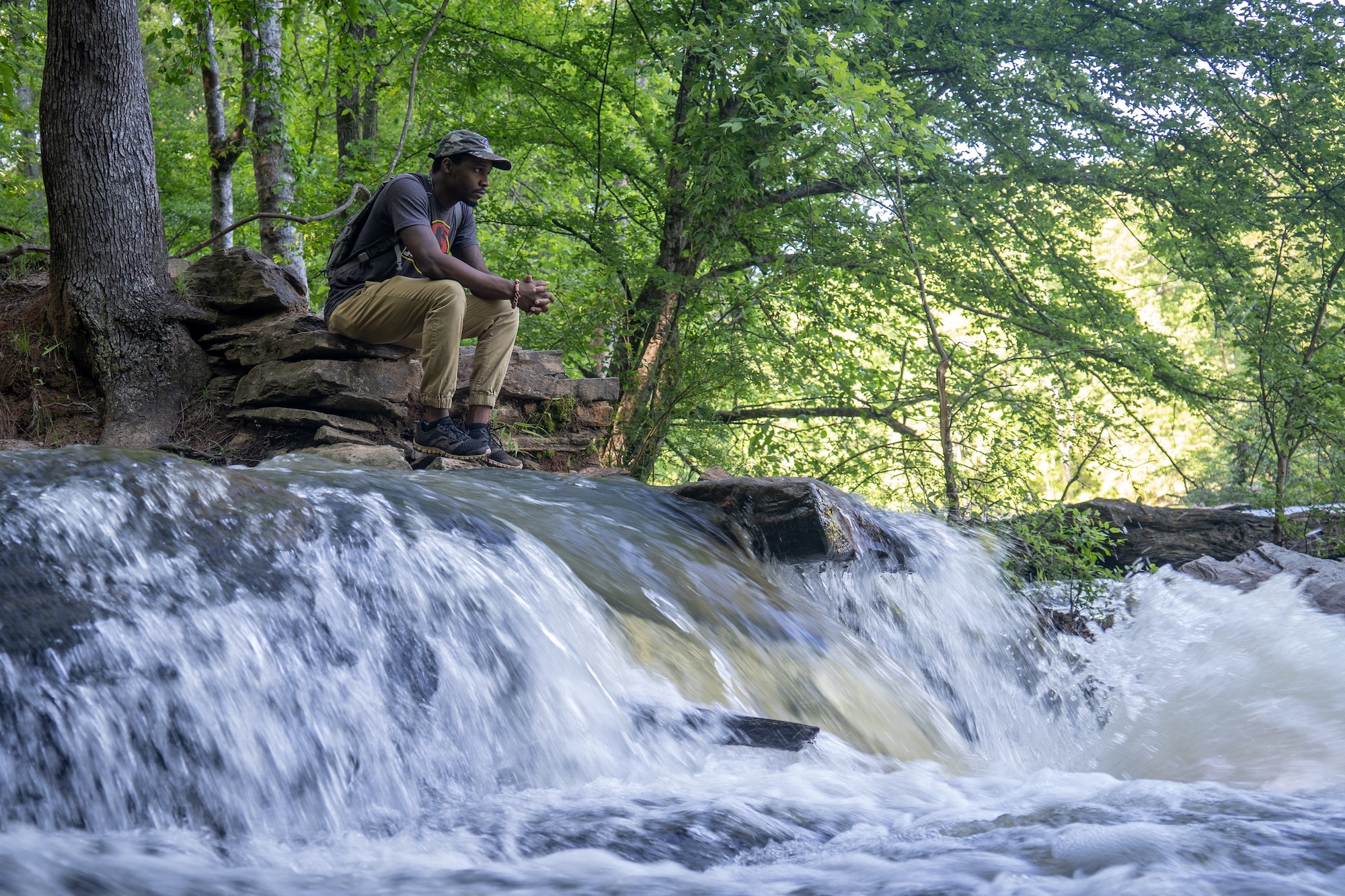 Staff Sgt. Shelton Sherrill, 403rd Wing Public Affairs specialist, self-reflects near a river May 1, 2020 at Sweetwater Creek State Park, Georgia. Sherrill believes that being around nature helps keep him calm, centered, and focused, which strengthens his resiliency. (U.S. Air Force photo by Staff Sgt. Shelton Sherrill)