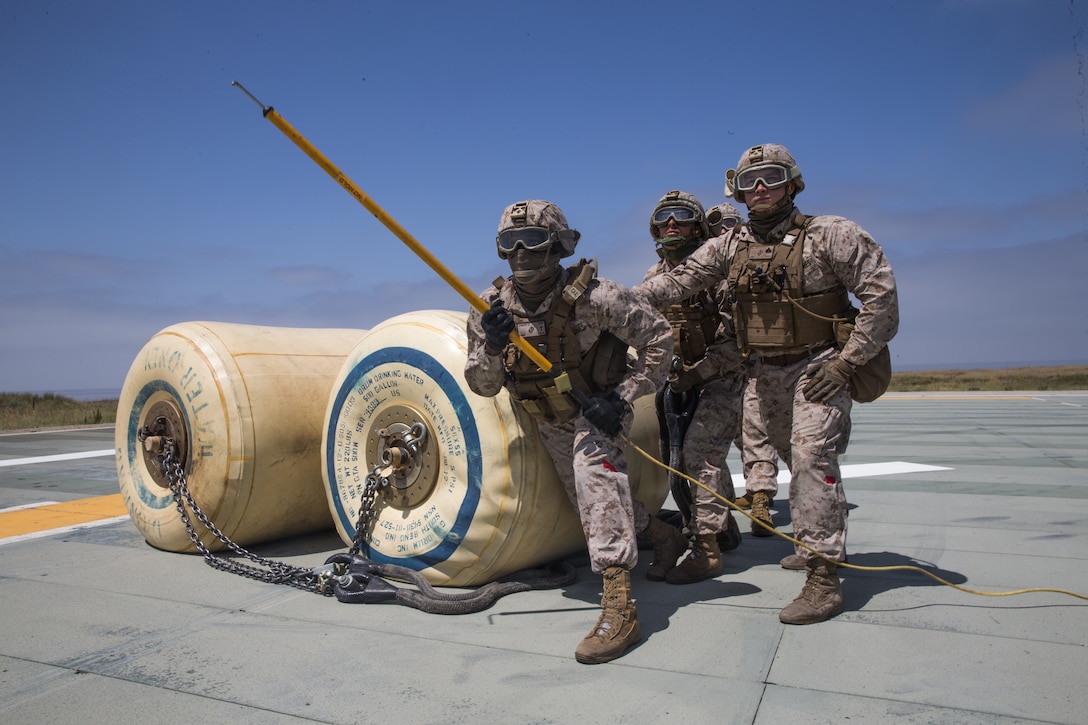 U.S. Marines with Combat Logistics Battalion 15, 15th Marine Expeditionary Unit, wait for a CH-53E Super Stallion with Marine Heavy Helicopter Squadron 466, 15th MEU, to move into position during helicopter support team training at Marine Corps Base Camp Pendleton, California, May 8, 2020. HSTs enable combined logistics operations and are able to conduct contingency operations, such as tactical recovery of aircraft and personnel missions. (U.S. Marine Corps photo by Lance Cpl. Brendan Mullin)