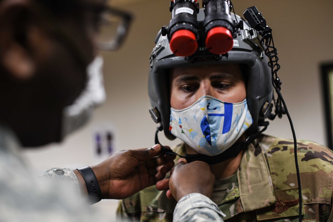 Maj. Tony Gorry, 344th Air Refueling Squadron and chief of group training, has his helmet fitted by Airman 1st Class Trezvon Miers, 22nd Operations Support Squadron aircrew flight equipment journeyman, April 21, 2020, at McConnell Air Force Base, Kansas. The crew prepared to execute the Air Force’s first night vision operational training mission on the KC-46A Pegasus. (U.S. Air Force photo by Senior Airman Alexi Bosarge)