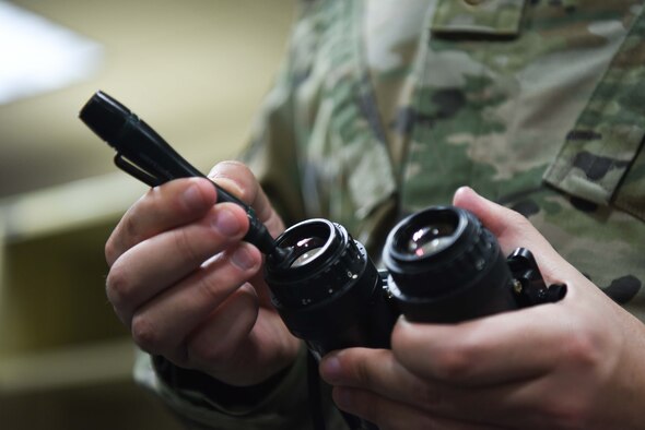 Staff Sgt. George Baylon, 22nd Operations Support Squadron aircrew flight equipment craftsman, cleans a pair of night vision goggles April 22, 2020, at McConnell Air Force Base, Kansas. Night vision goggles provide aircrew the capability to execute takeoff and landings on covertly lit runways. (U.S. Air Force photo by Senior Airman Alexi Bosarge)