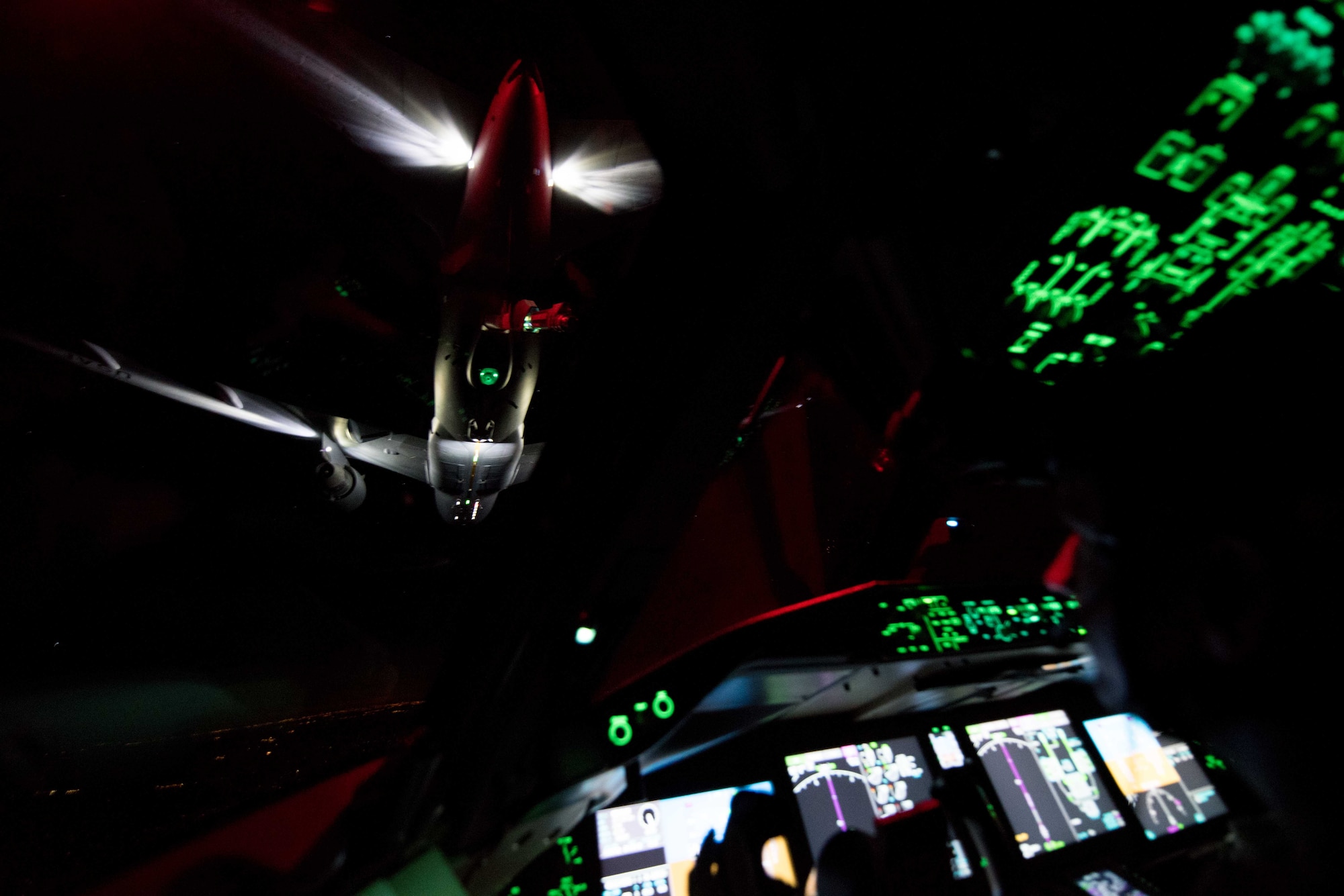 A 344th Air Refueling Squadron KC-46A Pegasus receives fuel from a 924th ARS KC-46 April 23, 2020. Aircrews practiced nighttime aerial refueling operations on the way to North Auxiliary Airfield, South Carolina, in conjunction with tactical takeoffs and landings using night vision goggles. (U.S. Air Force photo by Senior Airman Alexi Bosarge)