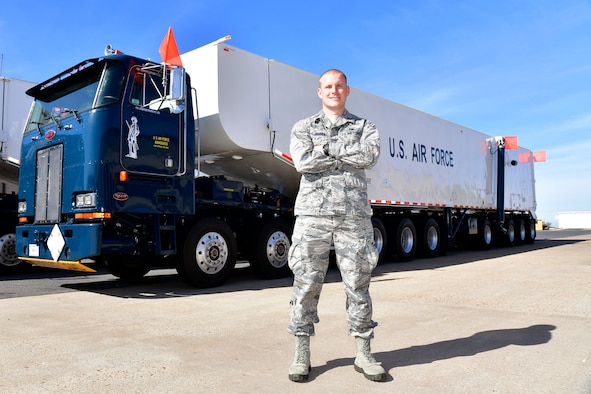 Capt. Scott A. Jensen, Ogden Air Logistics Complex, stands in front of a transporter erector vehicle.