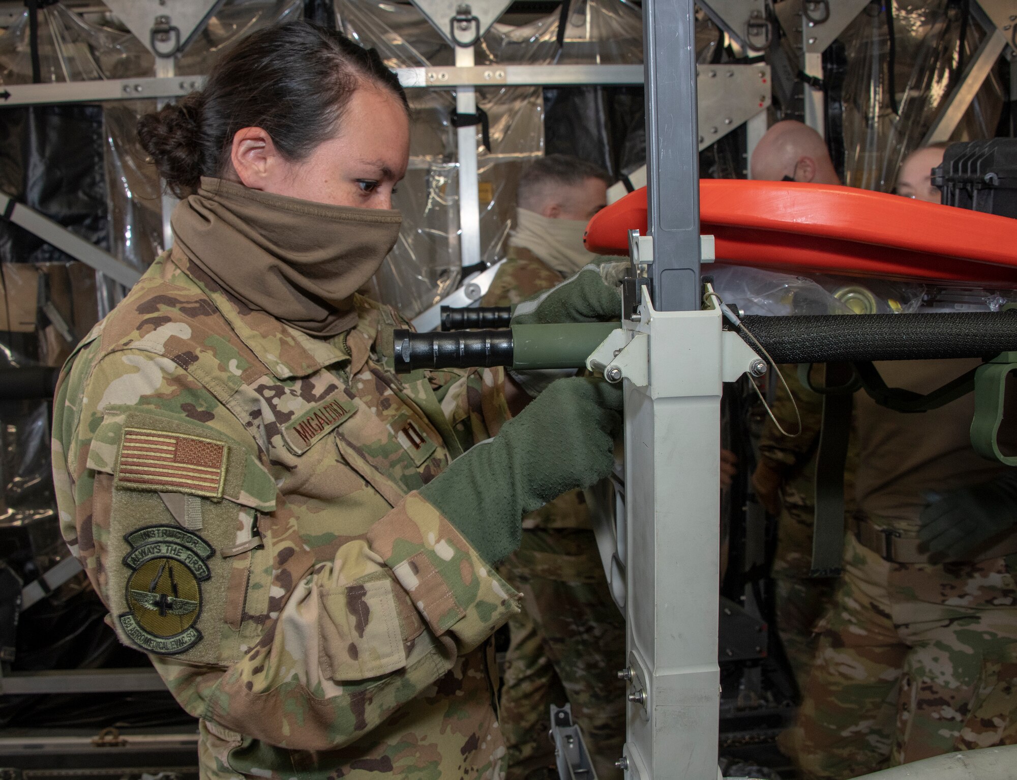 U.S. Air Force Capt. Kayleigh Migaleddi, 43rd Aeromedical Evacuation Squadron flight nurse from Pope Army Airfield, North Carolina, secures medical equipment on board a C-17 Globemaster III during a training exercise May 7, 2020, at Travis Air Force Base, California. The training focused on receiving and caring for potential COVID-19 patients using Transport Isolation System capsules. Travis AFB has a C-17 loaded with a TIS capsule on alert status to ensure the aircraft is ready to launch at a moment’s notice. The TIS unit allows the transport of individuals with highly contagious diseases without infecting other passengers or aircrew on the aircraft. (U.S. Air Force photo by Heide Couch)