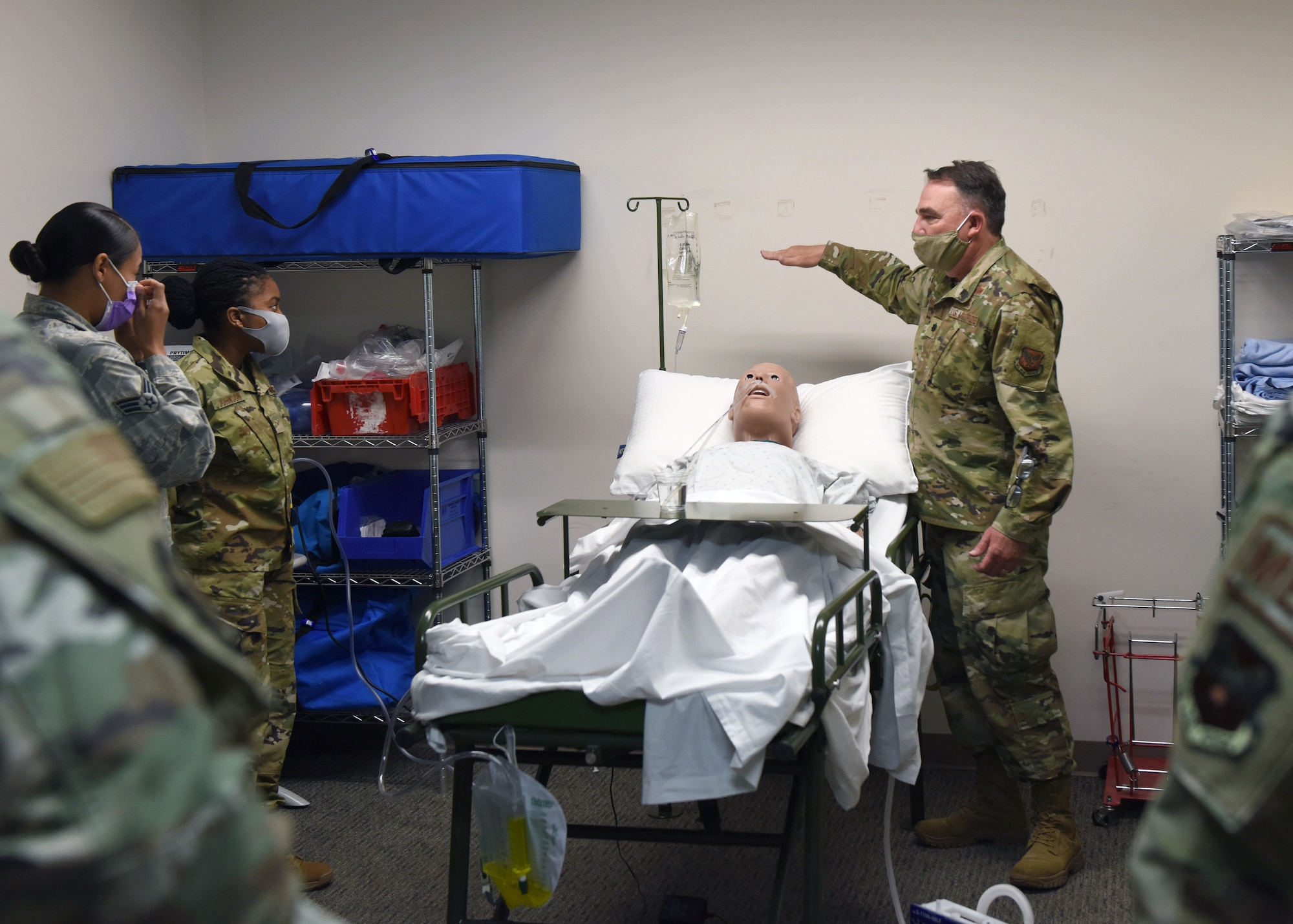 Lt. Col. Darren Damiani, 460th Medical Group chief nurse, conducts training at the Human Performance Center on Buckley Air Force Base, Colo., May 6, 2020. During the training session, Damiani ran through multiple scenarios that cover the fundamentals of inpatient treatment such as inserting nasogastric tubes, inserting catheters and much more. The purpose of the training is to ensure medical personnel are prepared in case they have to provide support for COVID-19 elsewhere. (U.S. Air Force photo by Airman 1st Class Haley N. Blevins)