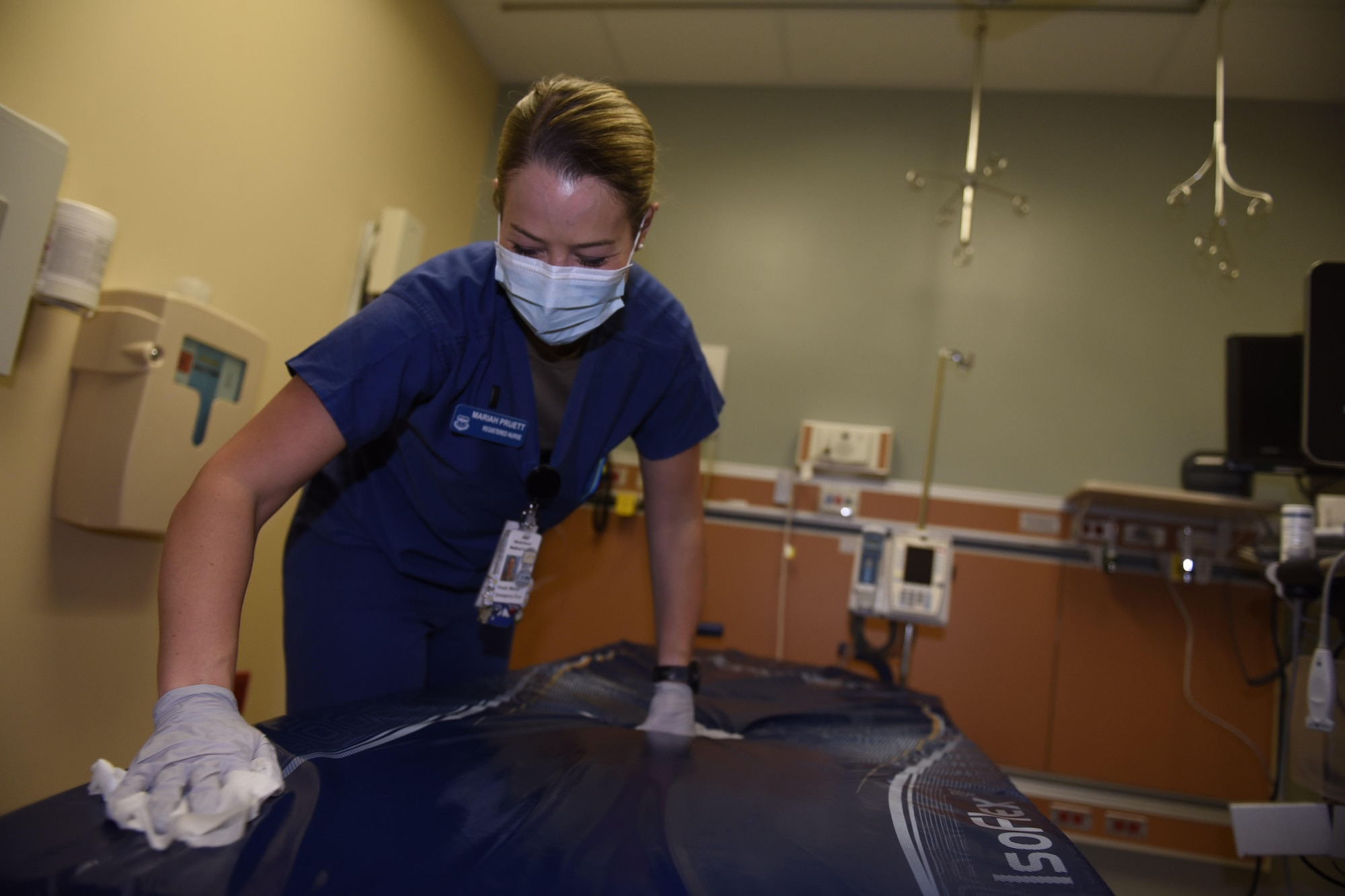 U.S. Air Force 1st Lt. Mariah Pruett, 60th Medical Operations Squadron clinical nurse, sanitizes a stretcher May 5, 2020, at Travis Air Force Base, California. May 6-12 is National Nurse Week, a week that celebrates medical professionals, like Pruett, who are on the frontlines of patient-centered care every day. (Air Force photo by Airman 1st Class Cameron Otte)