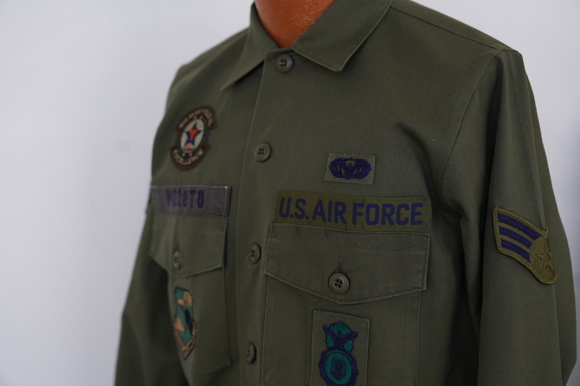 A Cotton Sateen Utility uniform owned by Chief Master Sgt. David Pizzuto, 81st Training Wing command chief, is displayed inside of the Levitow Training Support Facility at Keesler Air Force Base, Mississippi, May 6, 2020. Pizzuto, who is slated to retire this month, has served for 37 years and has worn every uniform the Air Force has ever known. (U.S. Air Force photo by Airman 1st Class Spencer Tobler)