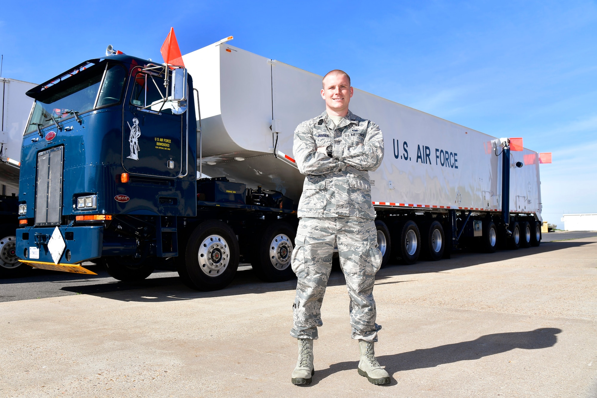 Capt. Scott A. Jensen, Ogden Air Logistics Complex, stands in front of a transporter erector vehicle.