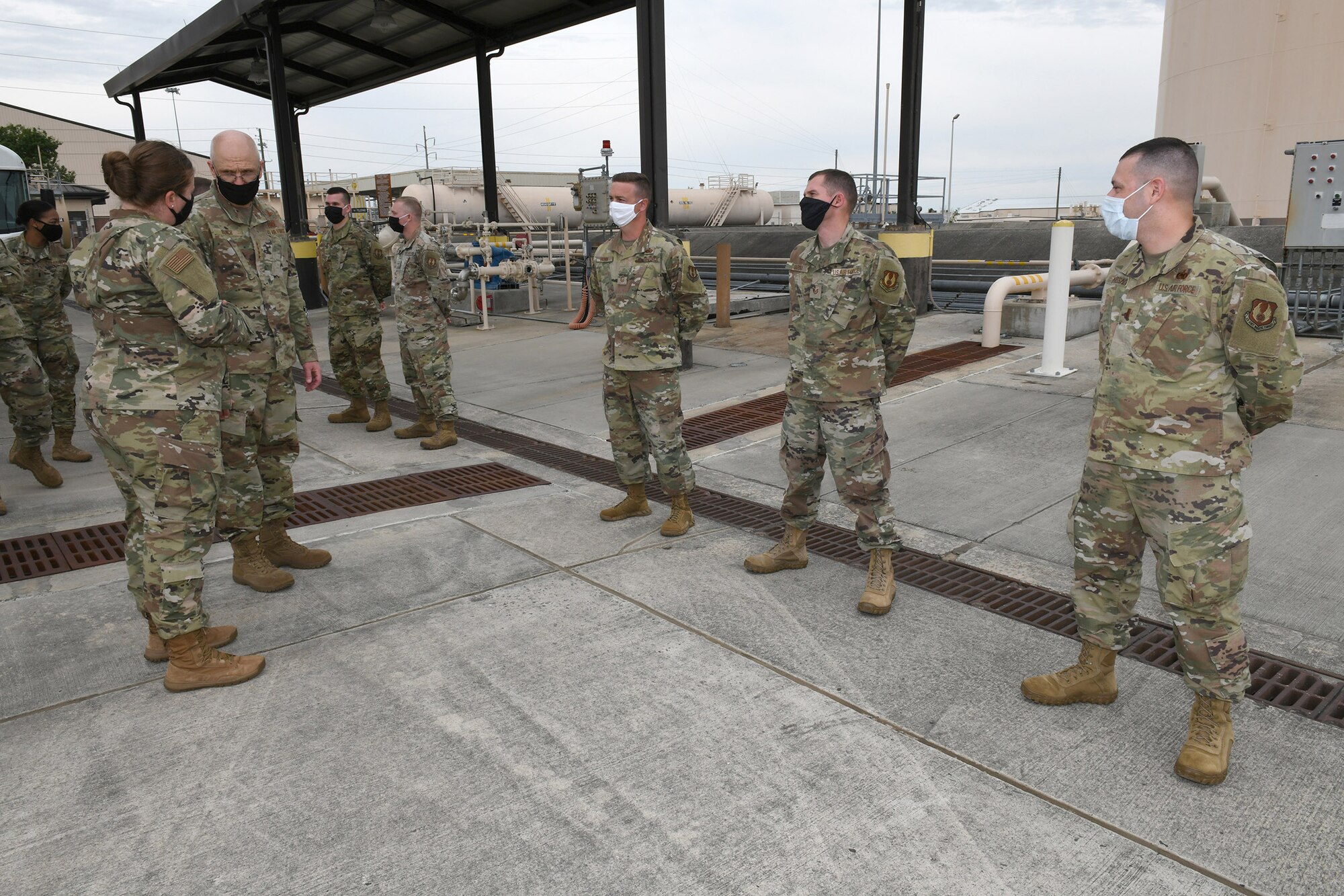 Photo shows the general talking to a line of Airmen.