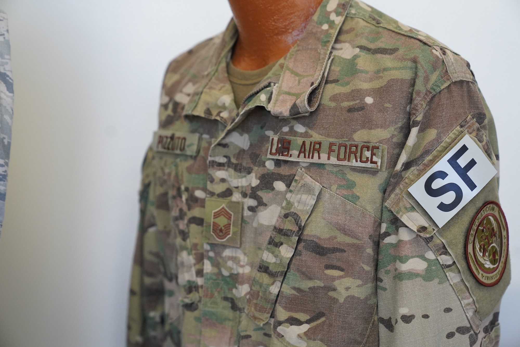 An Operational Camouflage Pattern uniform owned by Chief Master Sgt. David Pizzuto, 81st Training Wing command chief, is displayed inside of the Levitow Training Support Facility at Keesler Air Force Base, Mississippi, May 6, 2020. Pizzuto, who is slated to retire this month, has served for 37 years and has worn every uniform the Air Force has ever known. (U.S. Air Force photo by Airman 1st Class Spencer Tobler)