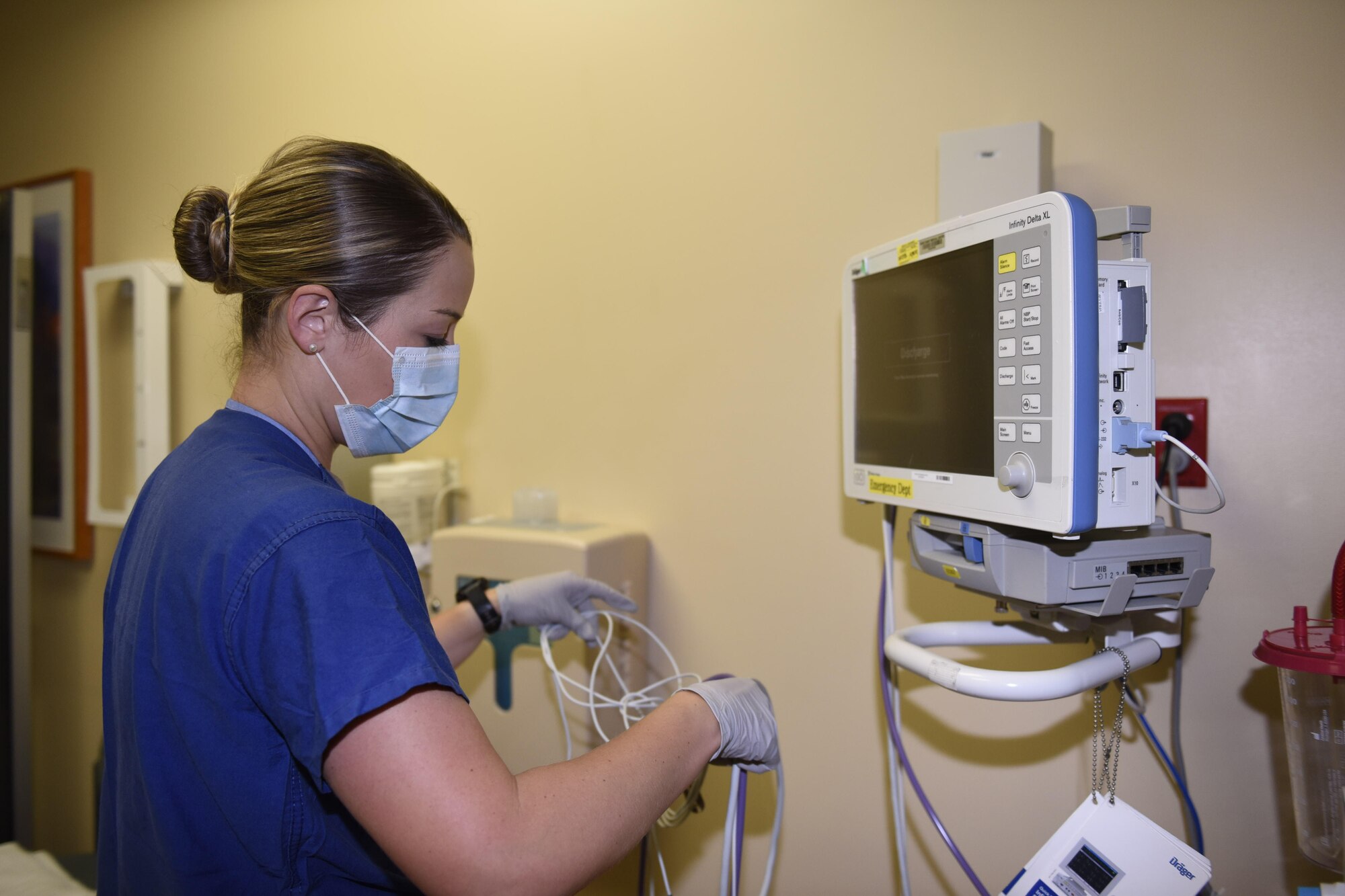 U.S. Air Force 1st Lt. Mariah Pruett, 60th Medical Operations Squadron clinical nurse, plugs in a Darger, vital signs monitor May 5, 2020, at Travis Air Force Base, California. May 6-12 is National Nurse Week, a week that celebrates medical professionals, like Pruett, who are on the frontlines of patient-centered care every day. (Air Force photo by Airman 1st Class Cameron Otte)