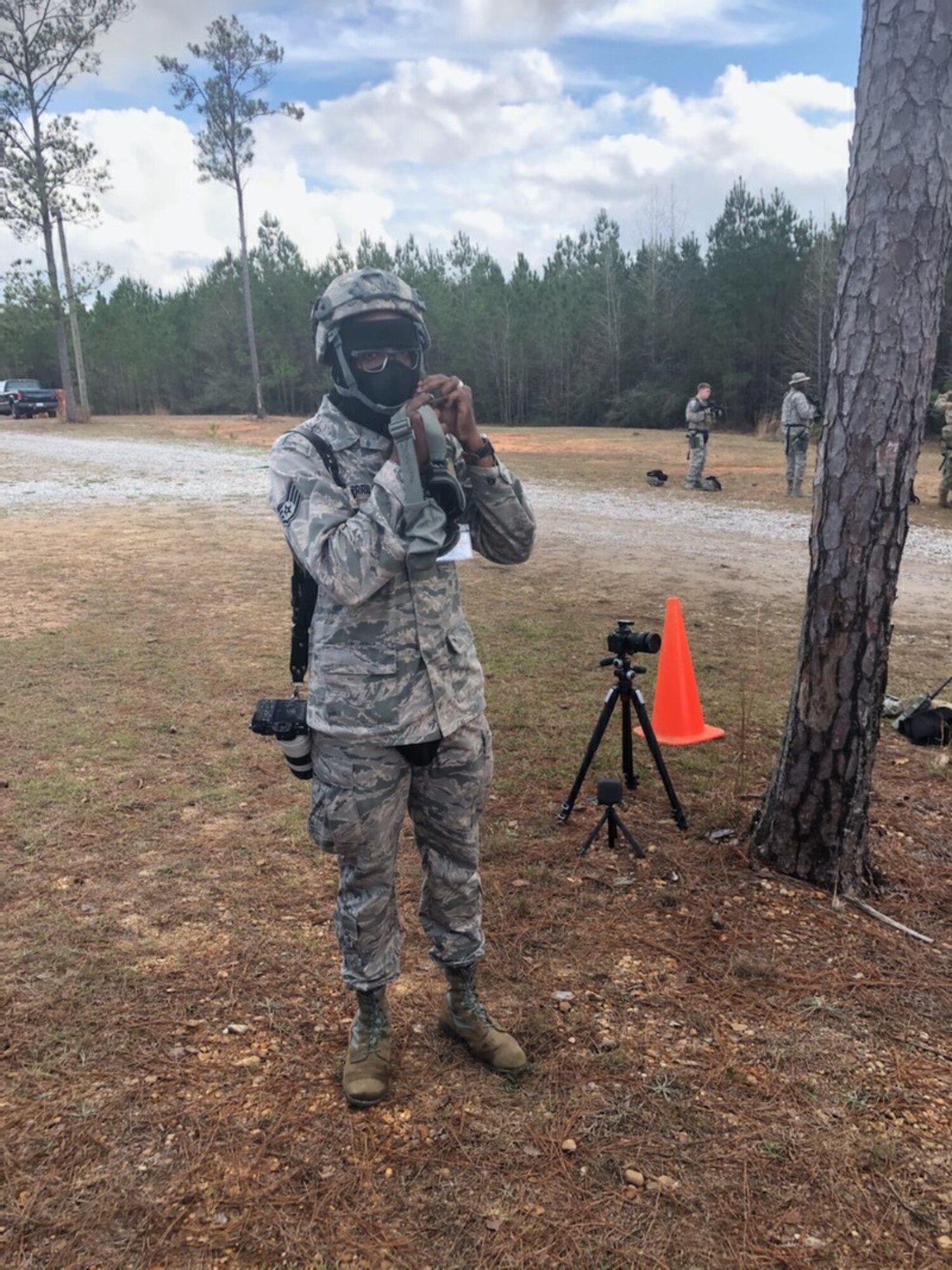 Staff Sgt. Shelton Sherrill, 403rd Wing public affairs specialist, puts a Kevlar helmet on before entering the exercise field during Operation Southern Comfort. Sherrill photographed members of the 403rd Security Forces during the exercise. (U.S. Air Force photo by Maj. Jonathan Brady)