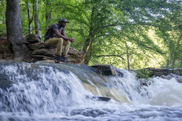 Staff Sgt. Shelton Sherrill, 403rd Wing Public Affairs specialist, self-reflects near a river May 1, 2020 at Sweetwater Creek State Park, Georgia. Sherrill believes that being around nature helps keep him calm, centered, and focused, which strengthens his resiliency. (U.S. Air Force photo by Staff Sgt. Shelton Sherrill)