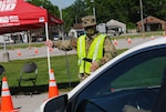 Kentucky National Guard Spc. Robert Acosta directs traffic at Lexington’s drive-through testing site. The site is part of Kentucky’s efforts to increase COVID-19 testing rates throughout the state.