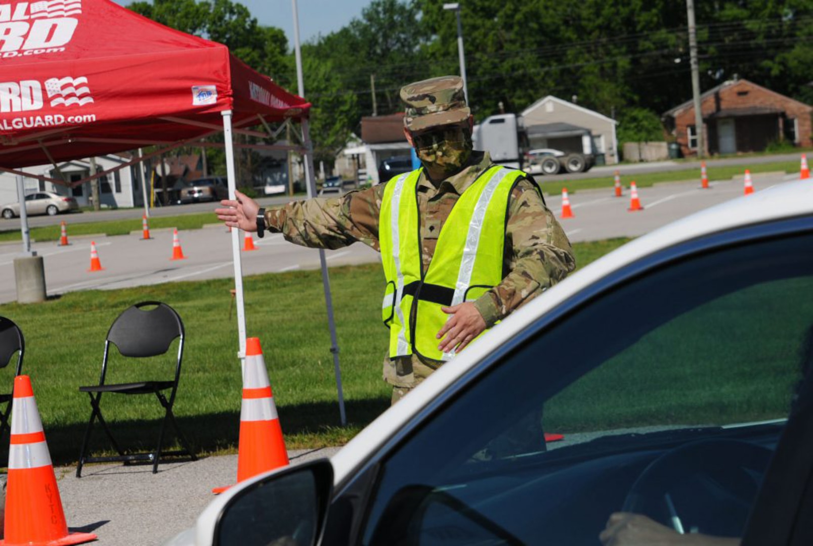 Kentucky National Guard Spc. Robert Acosta directs traffic at Lexington’s drive-through testing site. The site is part of Kentucky’s efforts to increase COVID-19 testing rates throughout the state.