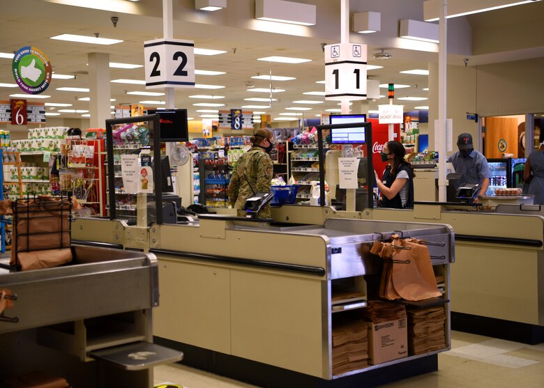 Customers purchase groceries at the base commissary on Goodfellow Air Force Base, Texas, May 12, 2020. Customers were required to wear face masks when inside the store during the COVID-19 pandemic. (U.S. Air Force photo by Airman 1st Class Abbey Rieves)