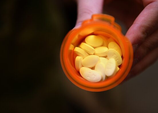 U.S. Air Force Capt. Adam Remme, 17th Medical Group pharmacy element chief, triple checks a prescription count before giving the medicine to the patient at the Ross Clinic pharmacy on Goodfellow Air Force Base, Texas, May 6, 2020. The pharmacy was scheduled to reinstate its curbside service for all military personnel, which overrides the previous prioritization of Active duty and their dependents only. (U.S. Air Force photo by Airman 1st Class Abbey Rieves)