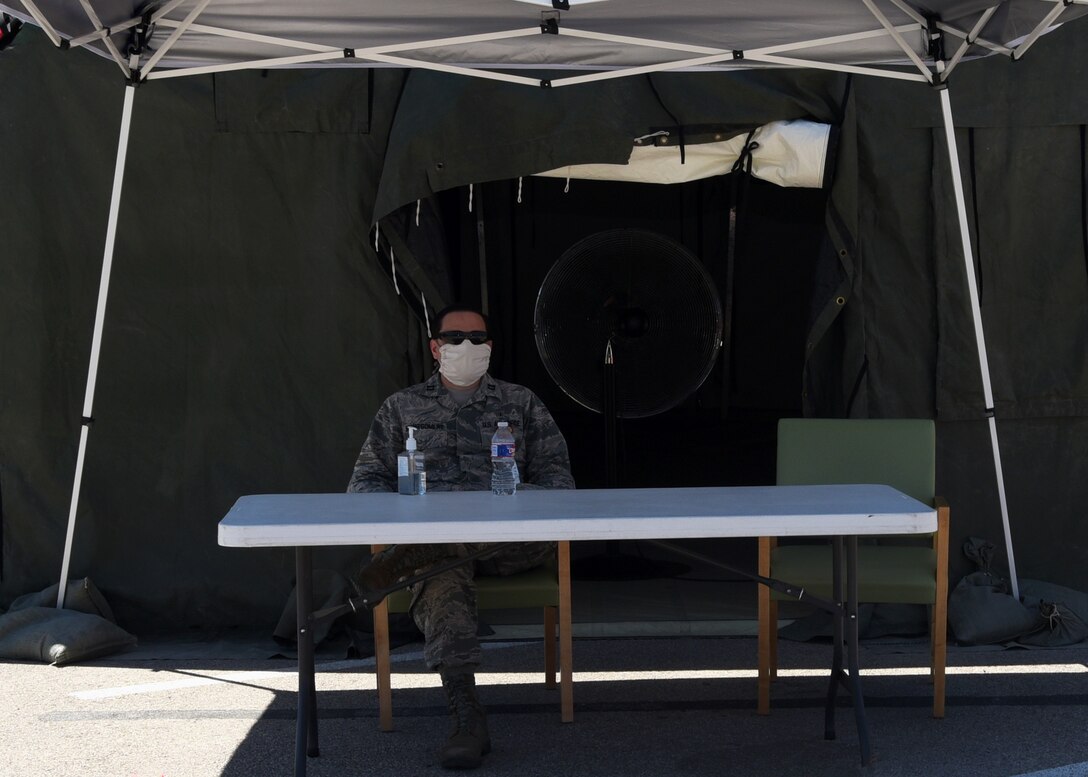 U.S. Air Force Capt. Thomas Montgomery, 17th Medical Group general dentist, operates the entry control point outside of the Ross Clinic pharmacy on Goodfellow Air Force Base, Texas, May 6, 2020. The pharmacy was scheduled to reinstate its curbside service for all eligible personnel, which overrides the previous prioritization. (U.S. Air Force photo by Airman 1st Class Abbey Rieves)