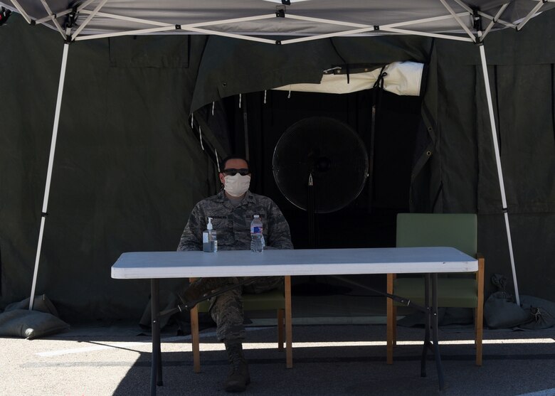 U.S. Air Force Capt. Thomas Montgomery, 17th Medical Group general dentist, operates the entry control point outside of the Ross Clinic pharmacy on Goodfellow Air Force Base, Texas, May 6, 2020. The pharmacy was scheduled to reinstate its curbside service for all eligible personnel, which overrides the previous prioritization. (U.S. Air Force photo by Airman 1st Class Abbey Rieves)