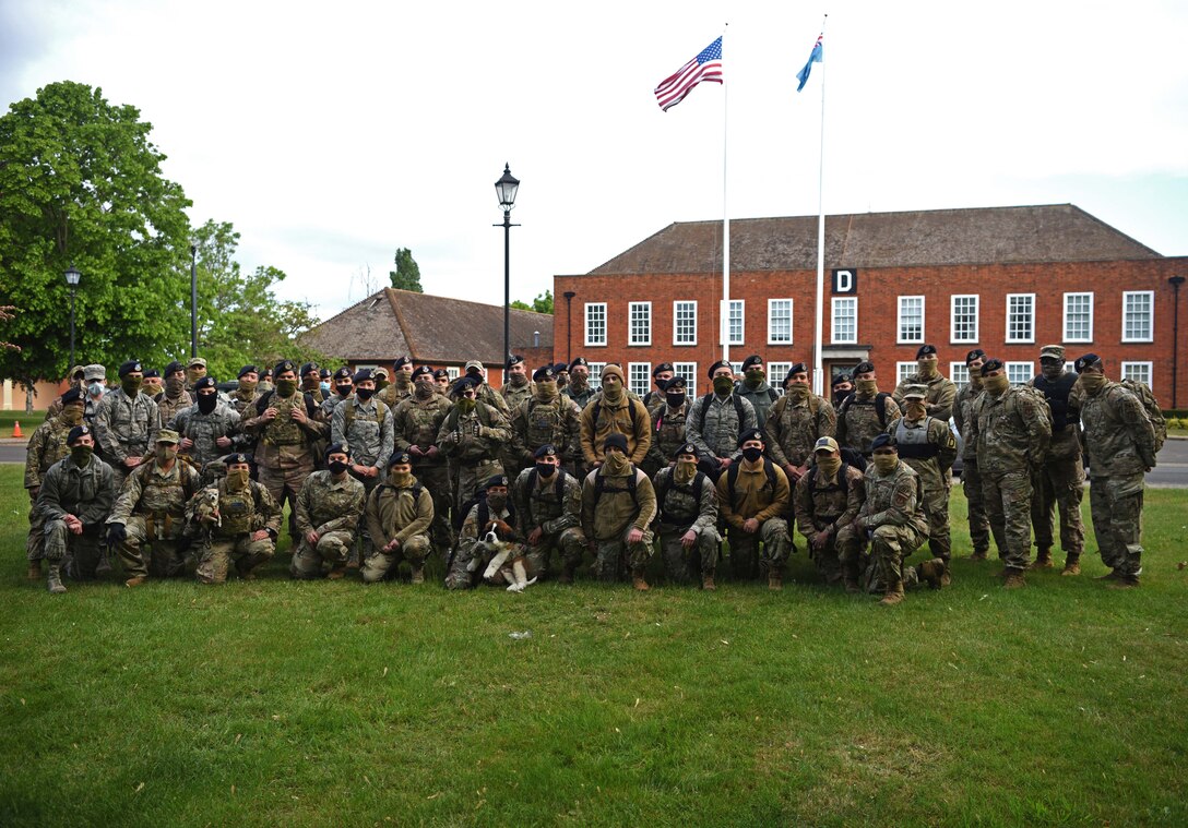 Members of the 100th Security Forces Squadron pose for a photo prior to their memorial ruck march to commemorate National Police Week 2020 at RAF Mildenhall, England, May 13, 2020. National Police Week is an observance in the United States which pays tribute to local, state and federal officers who’ve died or who’ve been disabled in the line of duty. (U.S. Air Force photo by Senior Airman Brandon Esau)