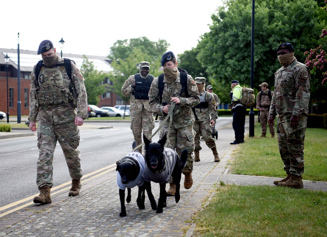 Airmen from the 100th Security Forces Squadron begin to march during the 100th SFS Memorial Ruck March to commemorate National Police Week at RAF Mildenhall, England, May 13, 2020. The ruck march was part of events to celebrate National Police Week, which is an observance in the United States that pays tribute to local, state and federal officers who’ve died or who’ve been disabled in the line of duty. (U.S. Air Force photo by Senior Airman Brandon Esau)