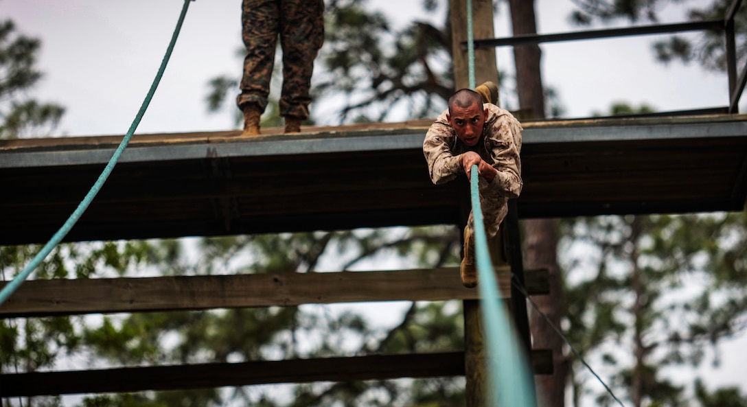 A recruit with Alpha Company, 1st Recruit Training Battalion, navigates an obstacle  during the Confidence Course aboard Marine Corps Recruit Depot Parris Island, S.C., Mar. 31, 2020. The Confidence Course is composed of various obstacles that both physically and mentally challenge recruits. (U.S. Marine Corps photo by Lance Cpl. Christopher McMurry)