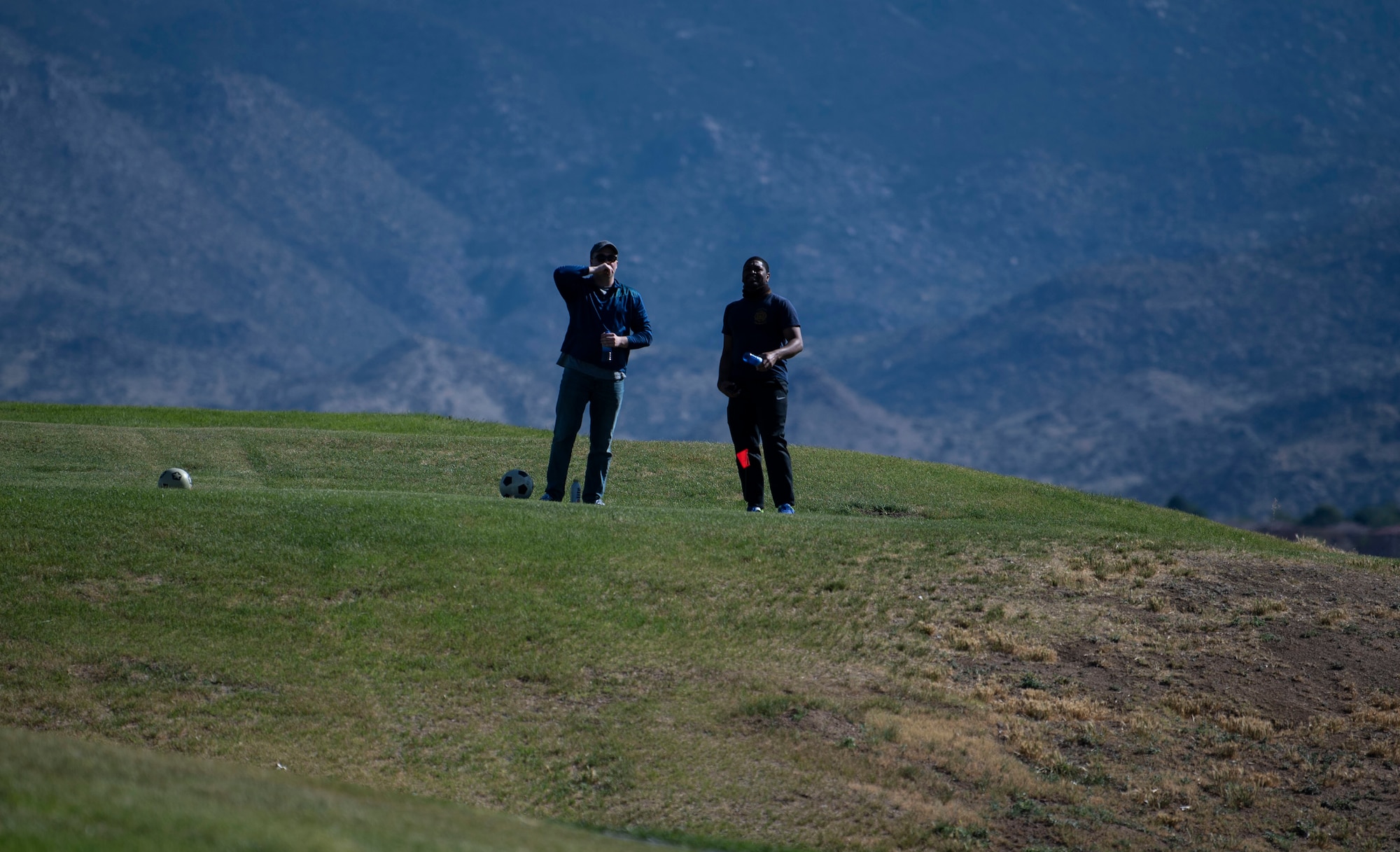 Airman stand on a hill.