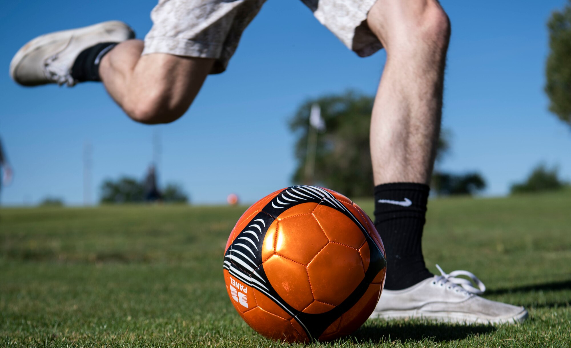 An Airman kicks a ball.