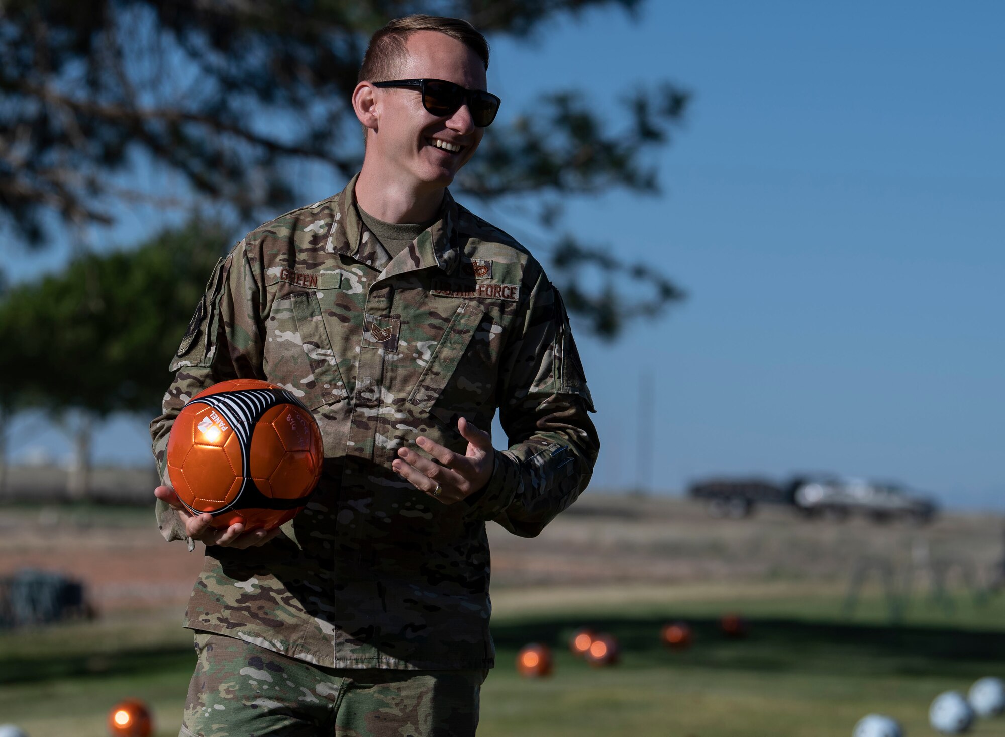 A defender plays footgolf.