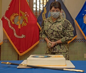 Cmdr. Louise Nellums, assigned to operations department of Naval Medical Forces Support Command (NMFSC), the senior nurse at NMFSC cuts a cake in honor of the Navy Nurse Corps 112th birthday.
