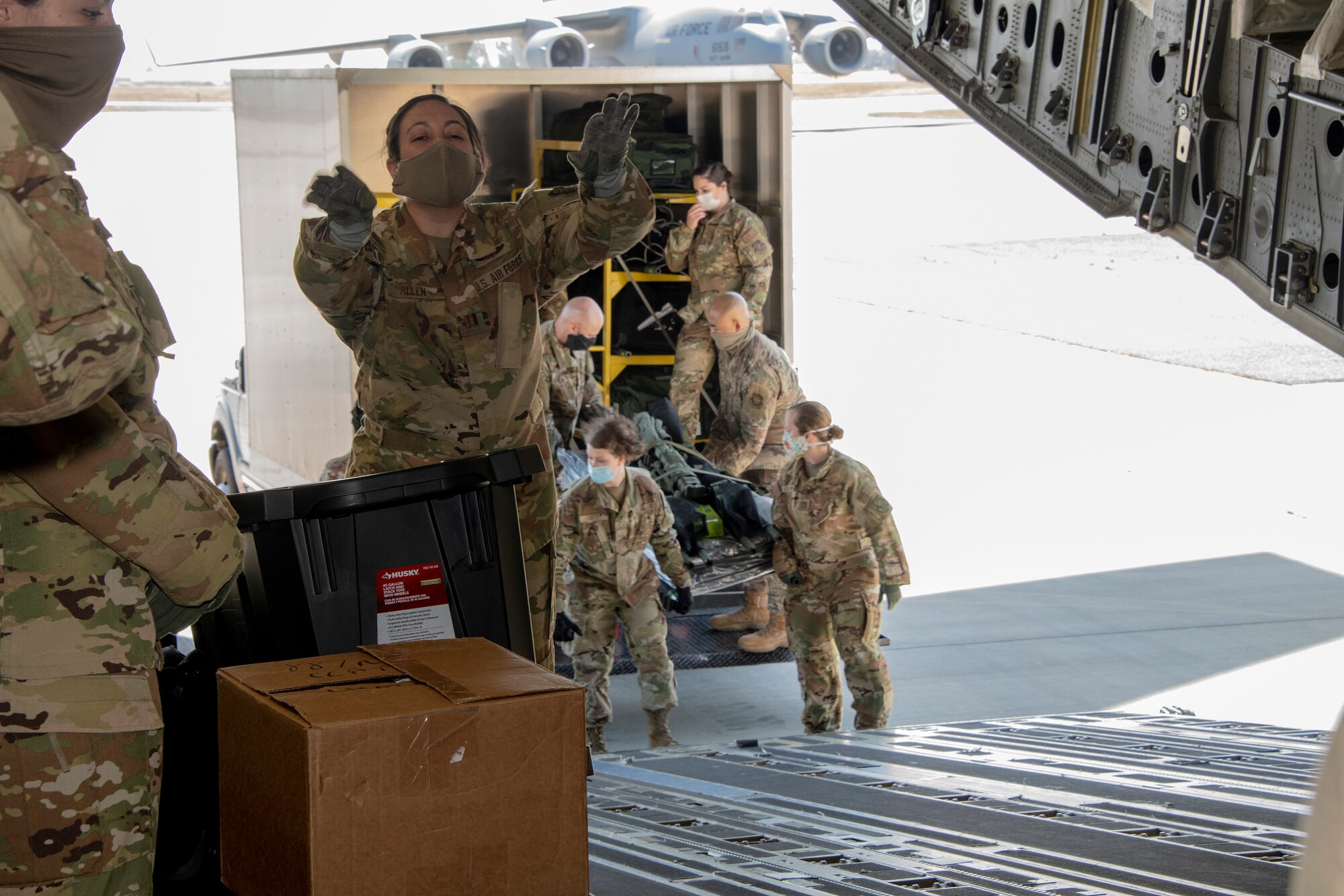 .S. Air Force COVID West Aeromedical Evacuation Task Force members load medical equipment and supplies into a C-17 Globemaster III during a training exercise May 7, 2020, at Travis Air Force Base, California. The training focused on receiving and caring for potential COVID-19 patients using Transport Isolation System capsules. Travis AFB has a - C-17 loaded with a TIS capsule on alert status to ensure the aircraft is ready to launch at a moment’s notice. The TIS unit allows the transport of individuals with highly contagious diseases without infecting other passengers or aircrew on the aircraft. (U.S. Air Force photo by Heide Couch)