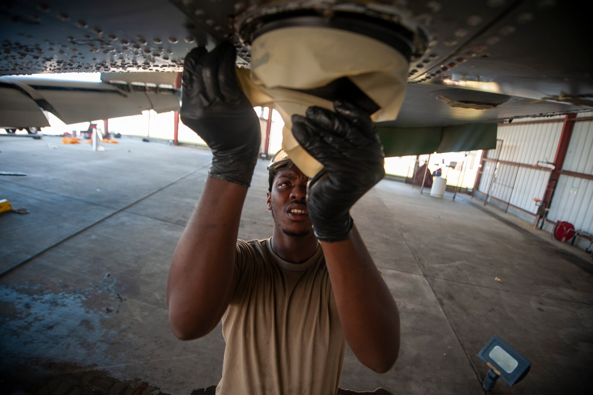 A photo of an Airman taping up an antenna