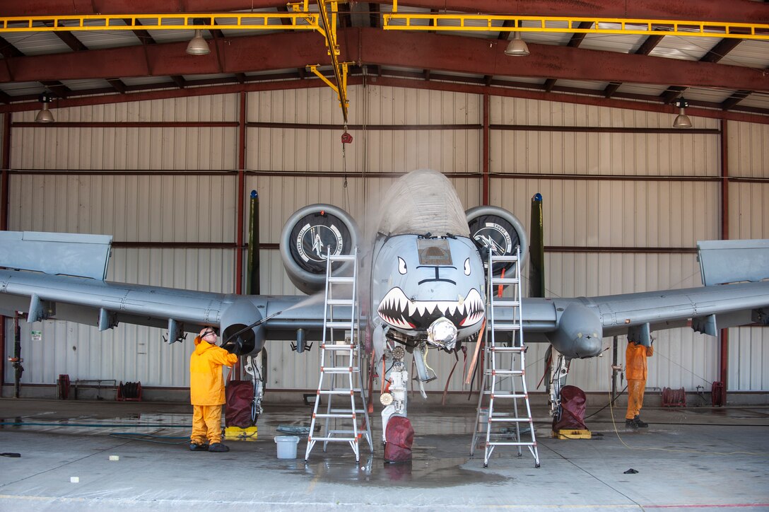 A photo of Airmen washing an aircraft.