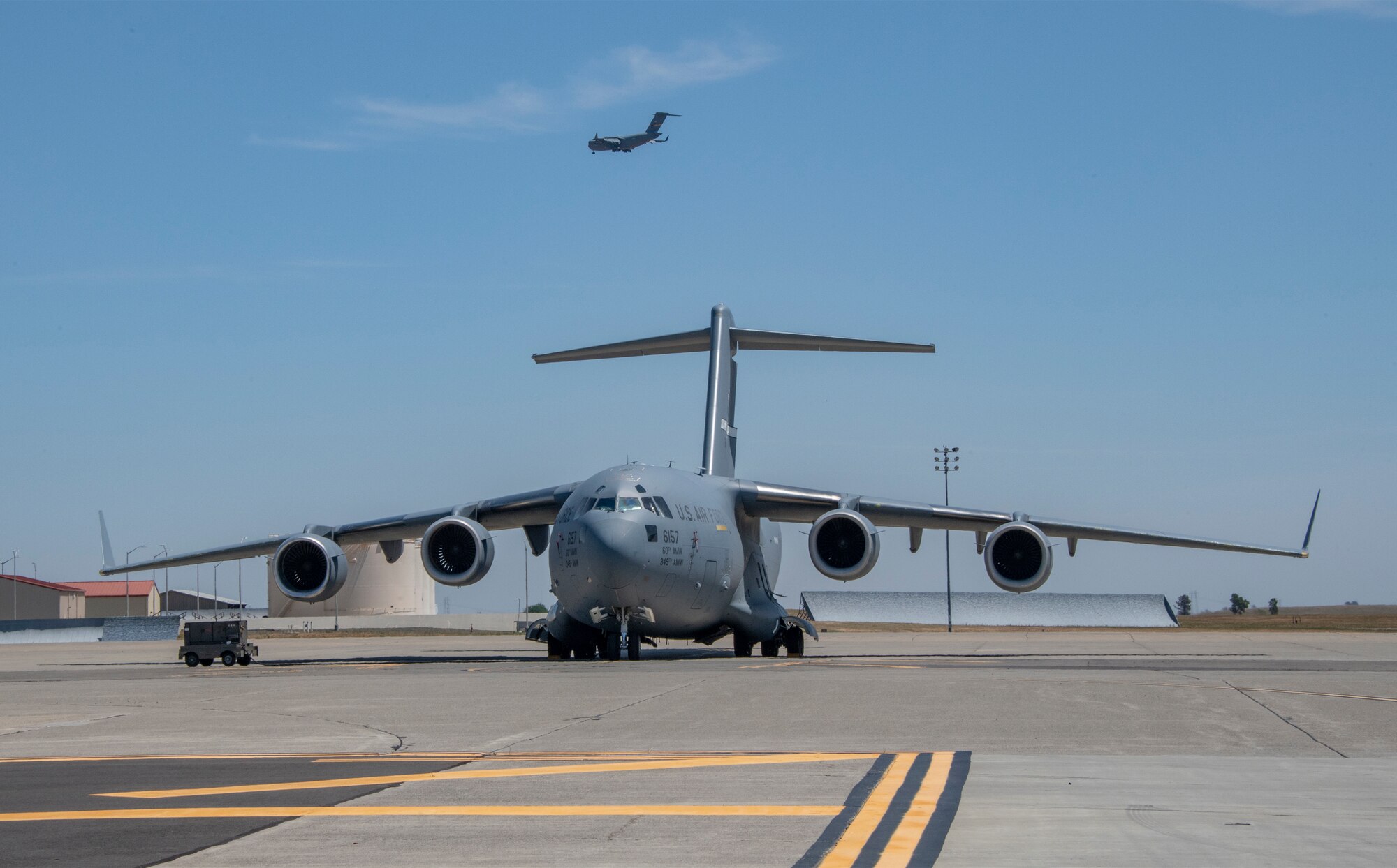 A C-17 Globemaster III sits on the flight line May 7, 2020, at Travis Air Force Base, California. The C-17, C-130H Hercules and C-130J Super Hercules are the only aircraft capable of carrying Transport Isolation System capsules. TIS capsules, which were initially engineered in response to the Ebola virus in 2014, allow the transport of individuals with highly contagious diseases without infecting other passengers or aircrew on the aircraft. (U.S. Air Force photo by Heide Couch)