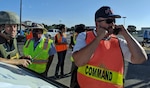 Incident commander Bob Ashley, deputy fire chief at Joint Base San Antonio Fire Emergency Services, communicates information to the Emergency Operations Center and requests additional resources to the scene during a mass casualty exercise at JBSA-Randolph.