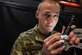 Staff Sgt. Arnold Wickham IV, 86th Maintenance Squadron non-destructive inspection craftsman, inspecting a piece of equipment with a flashlight