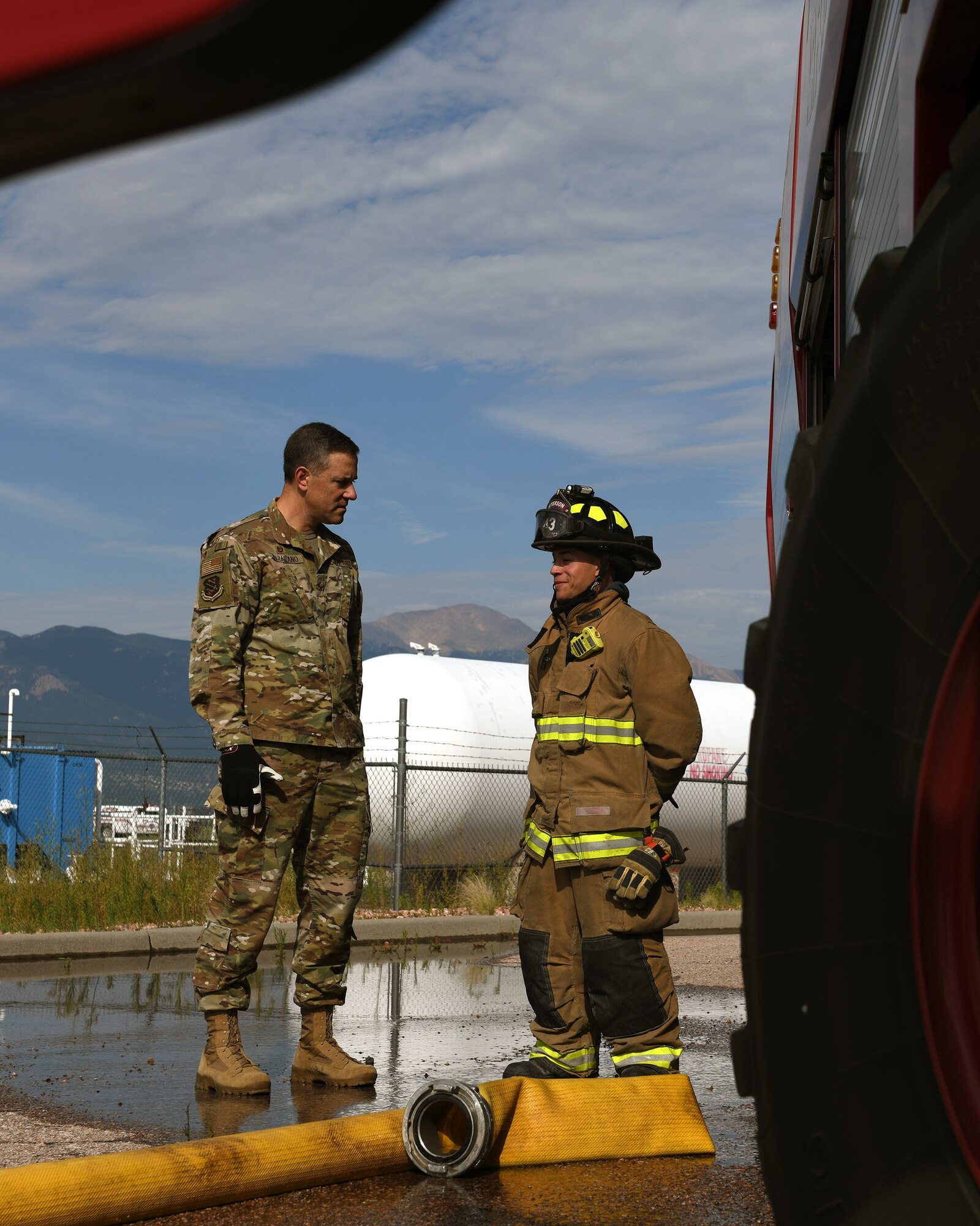 Col. Thomas Falzarano, 21st Space Wing commander, left, talks with Senior Airman Paul Karasiewicz, a 21st Civil Engineer Squadron firefighter Aug. 7, 2019, on Peterson Air Force Base, Colorado. Falzarano, as part of a tour of the 21st CES, met the many Airmen in the squadron and learned about what they do everyday. (U.S. Air Force photo by Airman 1st Class Andrew Bertain)