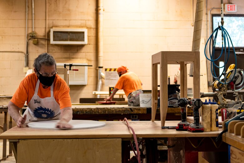 Photo of woodworkers working on projects.