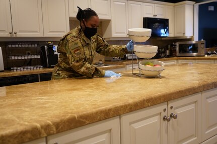 Air Force Staff Sgt. Parish Thacker, of Rochester, N.Y. sanitizes kitchen counters April 14, 2020 at Dover Air Force Base, Del. Thacker deployed from Niagara Falls Air Reserve Station, N.Y., to Air Force Mortuary Affairs Operations in support of the Fisher House for Families of the Fallen, but has been using her free time to coordinate resiliency events for other deployed Airmen.  (U.S. Air Force photo by 1st Lt. Elizabeth C. Andreas-Feeney)