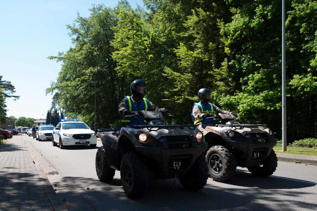 Caravan of police and emergency services vehicles.