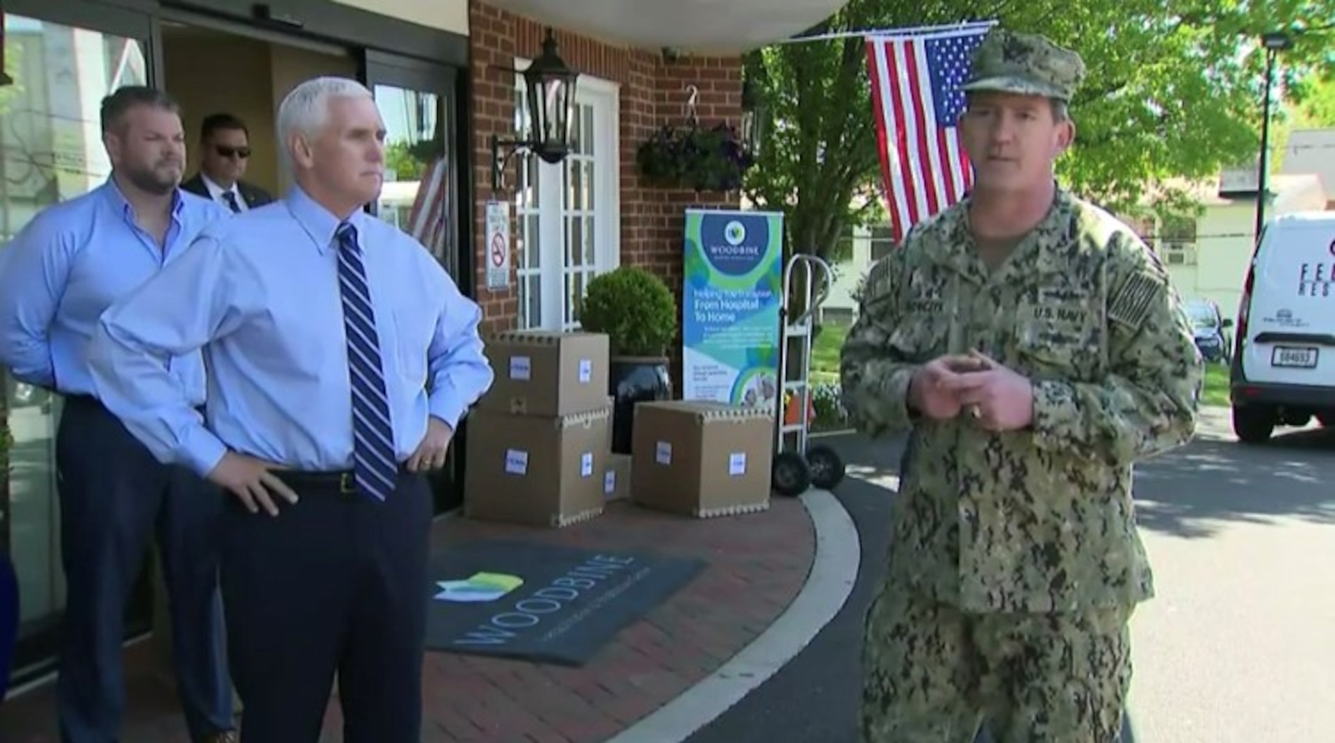 U.S. Navy Rear Admiral John Polowczyk, Federal Emergency Management Agency Supply Chain Task Force Lead speaks to the media as Vice President Michael Pence looks on in front Woodbine Rehabilitation & Healthcare Center, Alexandria, Va. where the first of $134 million worth of personal protective equipment kits were delivered May 7. The Defense Logistics Agency ordered the kits, which will be delivered to approximately 15,000 nursing homes throughout the U.S., to provide medical staff members with 14-days worth of protective eyewear, medical gowns, masks and nitrite gloves. The items were requested by the White House Coronavirus Task Force and funded by FEMA.