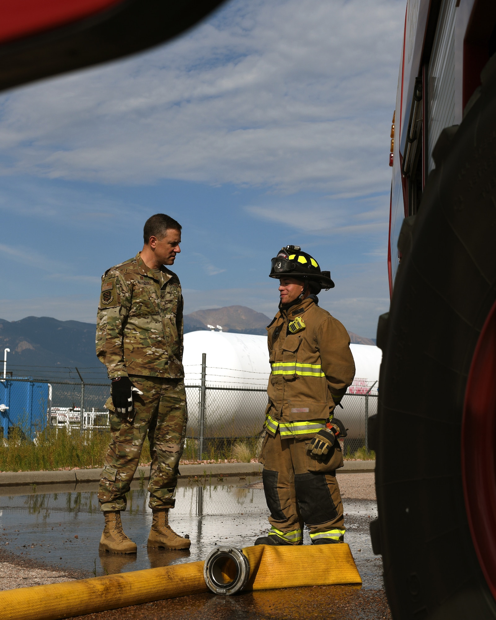 Col. Thomas Falzarano, 21st Space Wing commander, left, talks with Senior Airman Paul Karasiewicz, a 21st Civil Engineer Squadron firefighter Aug. 7, 2019, on Peterson Air Force Base, Colorado. Falzarano, as part of a tour of the 21st CES, met the many Airmen in the squadron and learned about what they do everyday. (U.S. Air Force photo by Airman 1st Class Andrew Bertain)