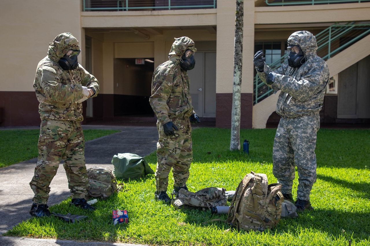 Soldiers putting on gear.